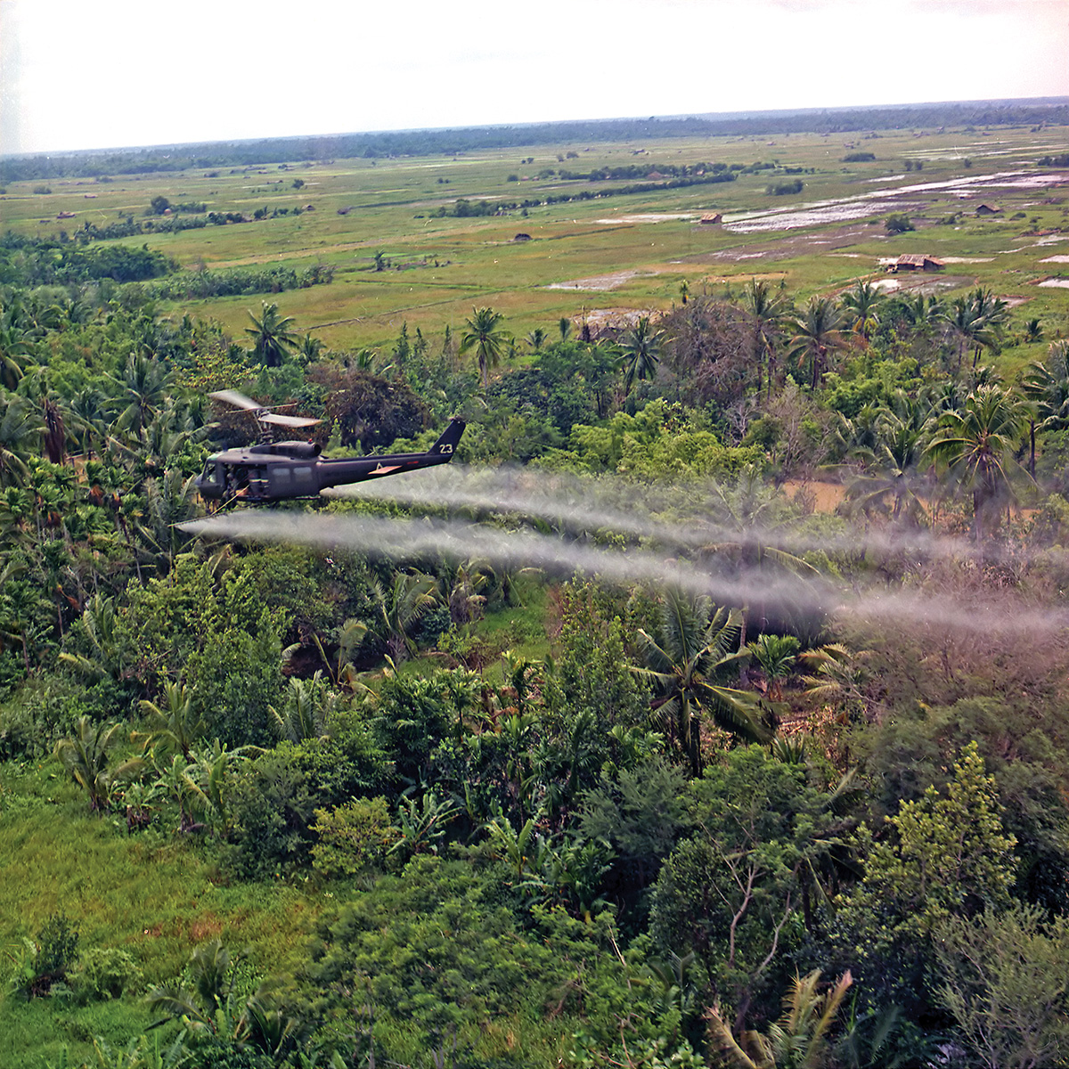 Helicopter spray mission during war in Vietnam